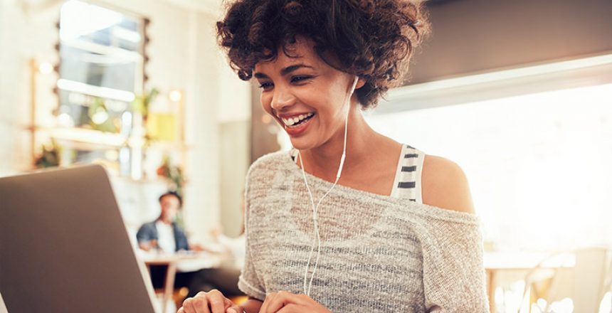 Image,Of,Happy,Woman,Using,Laptop,While,Sitting,At,Cafe.
